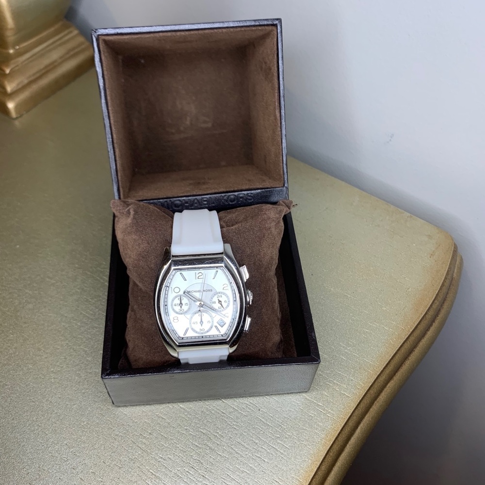 White silicone belt with silver dial.